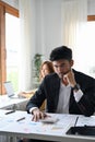 Professional and stressed asian businessman working on the financial report Royalty Free Stock Photo