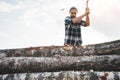 Professional strong lumberjack work on sawmill and sawing big tree with ax Royalty Free Stock Photo