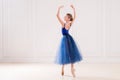 Professional student ballerina doing pointe shoes in a beautiful white room Royalty Free Stock Photo