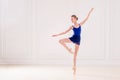 Professional student ballerina doing pointe shoes in a beautiful white room Royalty Free Stock Photo