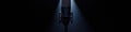 Professional studio microphone under dramatic spotlight in dark setting Royalty Free Stock Photo