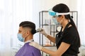 Professional stylist working with client in salon. Hairdressing services during Coronavirus quarantine