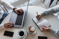 Professional successful head of the company sits with a laptop and interviews the girl manager  in the cafe. Royalty Free Stock Photo