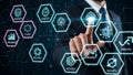 Businessman interacting with futuristic digital interface displaying hexagonal icons of technology and innovation Royalty Free Stock Photo