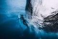 Professional surfer with surfboard dive underwater. Alone surfer under big ocean wave. Royalty Free Stock Photo