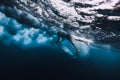 Professional surfer with surfboard dive underwater with big ocean wave. Royalty Free Stock Photo