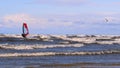 Professional surfer in the wind preparing the wind in the sea to the ocean. Windsurfer catches the wave in a storm. Concept of: Sp