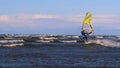 Professional surfer in the wind preparing the wind in the sea to the ocean. Windsurfer catches the wave in a storm. Concept of: Sp