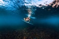 Professional surfer woman with surfboard dive underwater with under wave. Royalty Free Stock Photo