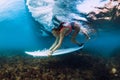 Professional surfer woman with surfboard dive underwater with ocean wave. Royalty Free Stock Photo