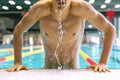 Professional swimmer emerges from the pool.