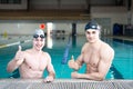 Professional swimmers gesturing thumbs up Royalty Free Stock Photo