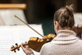 Professional symphonic string orchestra performing on stage and playing a classical music concert, violinist in a Royalty Free Stock Photo