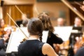 Professional symphonic string orchestra performing on stage and playing a classical music concert, violinist in a Royalty Free Stock Photo