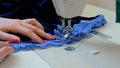 Professional tailor, fashion designer sewing clothes with sewing machine