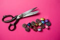 Professional tailor scissors and pile of metal bobbins Royalty Free Stock Photo