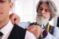 Professional tailor working with client in atelier, closeup Royalty Free Stock Photo