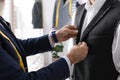 Professional tailor working with client in atelier, closeup Royalty Free Stock Photo