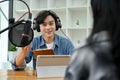 Talented asian male radio host enjoy discussing and interviewing his female special guest