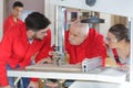 Professional teacher showing carpentry machinery to students Royalty Free Stock Photo