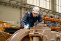 Professional technician or engineer worker hold light stick to check and fix the problem of part of electric train in factory or Royalty Free Stock Photo