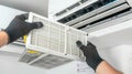 Professional technician installing new air filter in HVAC system for enhanced performance and clean air. HVAC service Royalty Free Stock Photo