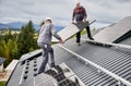 Professional technicians carrying solar PV battery