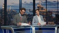 Professional television presenters talk evening newscast modern studio closeup