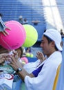 Professional tennis player Kei Nishikori signing autographs after practice for US Open 2014 Royalty Free Stock Photo