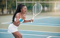 Professional tennis player screaming in excitement after a match. African american woman cheering her success after a Royalty Free Stock Photo