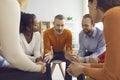 Professional therapist talking to diverse patients during a group therapy session Royalty Free Stock Photo