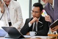 Thoughtful adult Asian businessman planning his business project with his team Royalty Free Stock Photo