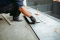 Professional tiler and ceramic tiles worker on construction site Royalty Free Stock Photo