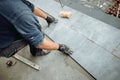 Professional tiler and ceramic tiles worker on construction site Royalty Free Stock Photo