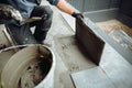 Professional tiler and ceramic tiles worker on construction site. Royalty Free Stock Photo