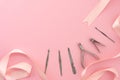 Professional tools of manicure set for nail care on a pink background with a bow. Beauty concept. Copyspace mockup