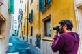 Professional travel photographer captures a shot of a narrow street in an Italian city Royalty Free Stock Photo