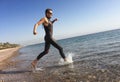 Professional triathlete practicing in open water. Plunge in sea.