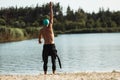 Professional triathlete before swimming in river& x27;s open water. Man wearing swim equipment practicing triathlon on the Royalty Free Stock Photo