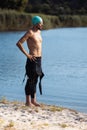 Professional triathlete before swimming in river& x27;s open water. Man wearing swim equipment practicing triathlon on the Royalty Free Stock Photo