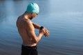 Professional triathlete before swimming in river& x27;s open water. Man wearing swim equipment practicing triathlon on the Royalty Free Stock Photo