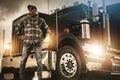 Professional Truck Driver Proudly Standing in Front of His Heavy Duty Vehicle Royalty Free Stock Photo