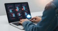 Professional using a laptop to analyze complex data visualizations and coding interfaces Royalty Free Stock Photo