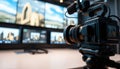 Professional Video Camera Filming in Studio Capturing Live Broadcast with Dynamic Screens Royalty Free Stock Photo