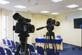 Professional video camera mounted on a tripod to record video during a press conference, an event, a meeting of journalists. Royalty Free Stock Photo