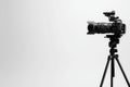 professional video camera on tripod against white background showcasing its sleek design and advanced features Ideal for Royalty Free Stock Photo