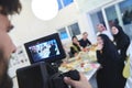 Professional videograph recording video while Muslim family having iftar together during Ramadan Royalty Free Stock Photo