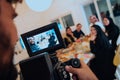 Professional videograph recording video while Muslim family having iftar together during Ramadan Royalty Free Stock Photo