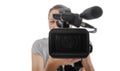 A professional videographer holding a video camera while recording Royalty Free Stock Photo