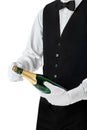 Professional waiter opening bottle of champagne